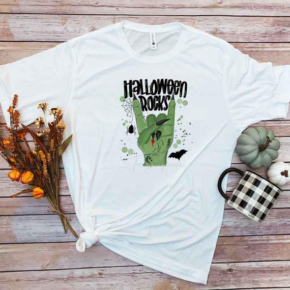 Halloween Rocks Sublimation Transfer, Halloween themed t-shirt with a spooky hand making a rock gesture, decorated with a spider, bat, and green splatters.
