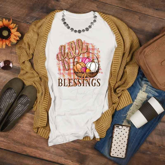 Fall Blessings Sublimation Transfer, white T-shirt with fall-themed pumpkin design and the word 'fall' in cursive, surrounded by autumn leaves and plaid patterns.