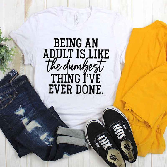 Being An Adult Is... Sublimation Transfer, white T-shirt with black text, casual jeans, black sneakers, and a yellow garment displayed for fashion or apparel decoration.