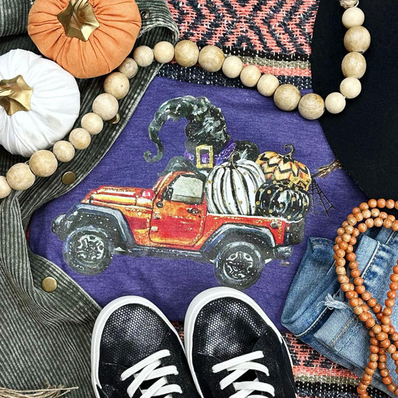 Halloween Jeep Screen Print Heat Transfer, festive Halloween themed heat transfer with a red Jeep carrying pumpkins and spooky elements, on purple fabric.