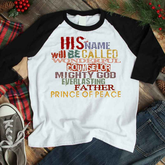 His Name Will Be Called Sublimation Transfer, a colorful graphic T-shirt with a Christmas holiday message on a wooden background.