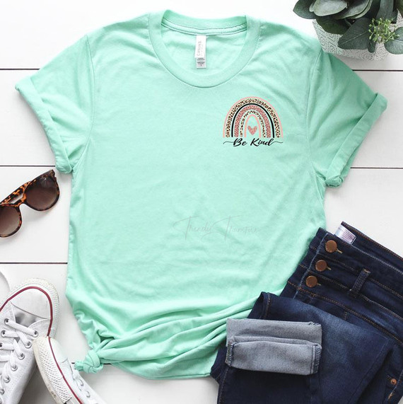 Be Kind Rainbow Pocket Screen Print Heat Transfer, light green t-shirt with rainbow and heart design and 'Be Kind' text on the front.