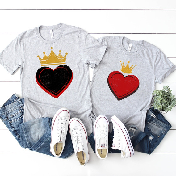 King of Hearts Sublimation Transfer, two gray t-shirts with heart and crown designs, paired with jeans and white sneakers on a white wooden surface with a small potted plant.