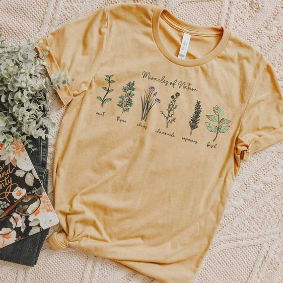 Miracles Of Nature Screen Print Heat Transfer T-Shirt, featuring botanical illustrations and handwritten labels of various herbs and plants.