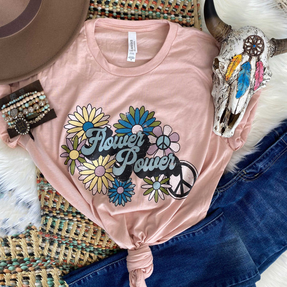 Flower Power Screen Print Heat Transfer on a pink t-shirt with floral and peace sign design, surrounded by bohemian accessories and a decorative skull with colorful feathers.