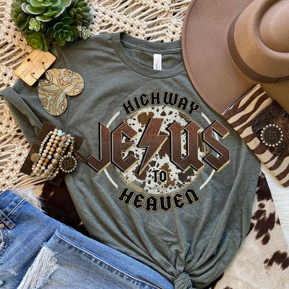 Highway To Heaven Screen Print Heat Transfer T-shirt, motivational graphic design with edgy font and lightning bolt, placed among fashion accessories and hats.