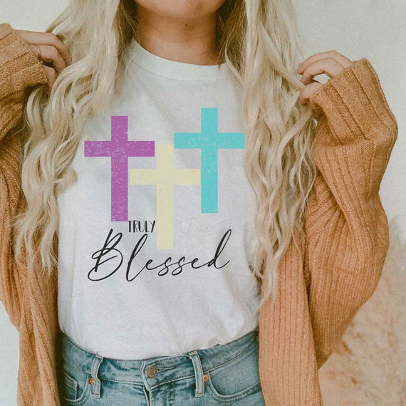 Truly Blessed Sublimation Transfer, colorful cross design on white t-shirt with the words 'Truly Blessed' in stylish font.