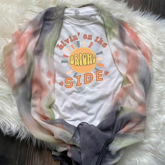 Livin' On The Bright Side Sublimation Transfer, colorful graphic tee with sun and positive message on a white T-shirt with a multicolored scarf around it.