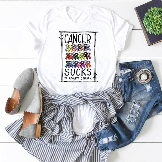 Cancer Sucks In Every Color Sublimation Transfer, a colorful design featuring rainbow-colored awareness ribbons and the text 'Cancer Sucks In Every Color' on a white T-shirt.