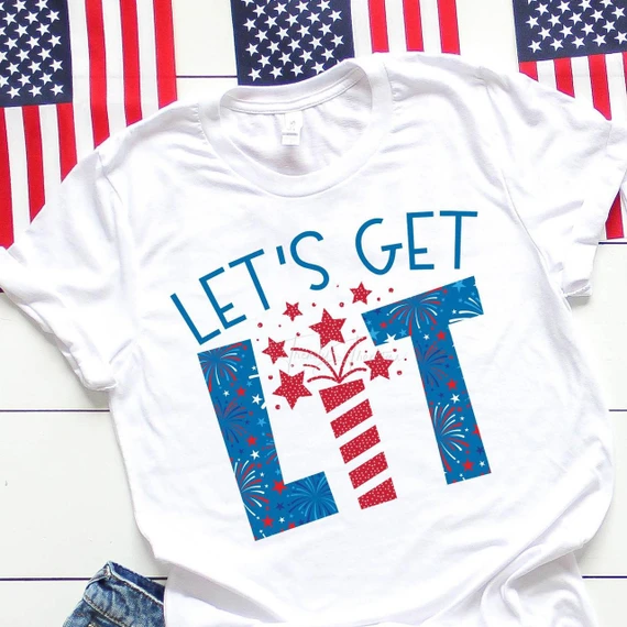 Let's Get Lit Firework Fourth Of July Patriotic Sublimation Transfer, a festive white T-shirt with red, white, and blue fireworks and stars design suited for Independence Day celebrations.