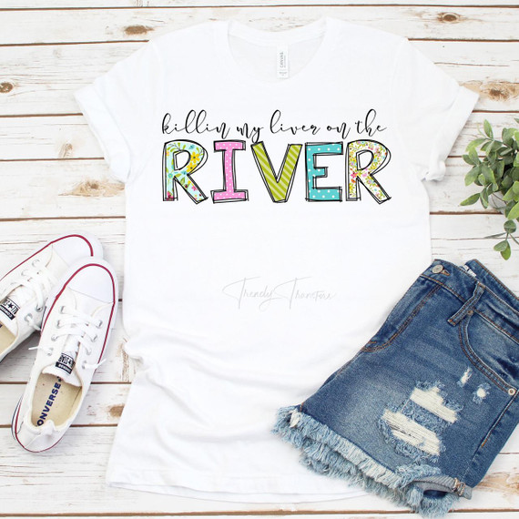 Killin My Liver On The River Sublimation Transfer, colorful and playful design on a white T-shirt with jeans and sneakers on a wooden background.
