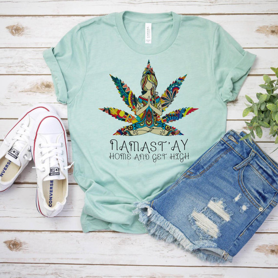 Namastay Home and Get High Humor Sublimation Transfer T-shirt, a mint green T-shirt featuring a colorful, intricate illustration of a person in a yoga pose with a large marijuana leaf and the humorous text 'Namastay Home and Get High' printed on it.