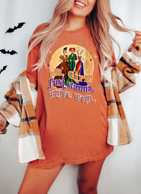 Oh, Girls Just Wanna Have Fun Screen Print Heat Transfer, colorful design featuring three women in stylish outfits above the text "oh, Girls Just Wanna Have Fun" on an orange t-shirt worn by a smiling woman.