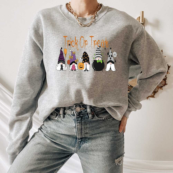 Trick Or Treat Gnomes DTF Heat Transfer, Halloween themed graphic t-shirt with colorful gnome characters in costumes and Halloween decorations.