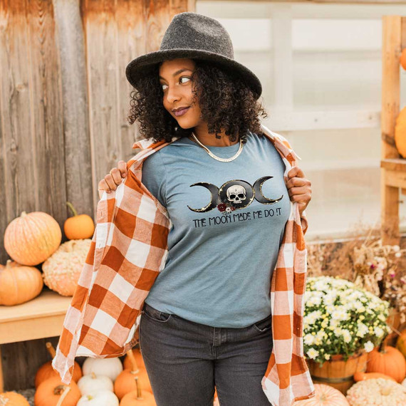 The Moon Made Me Do It DTF Heat Transfer, woman wearing a t-shirt with moon phases and skull graphic at a pumpkin patch.