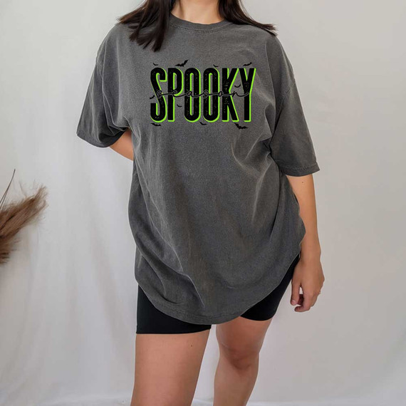Spooky Season DTF Heat Transfer, Halloween-themed black and green spooky text with bats graphic on a gray oversized T-shirt.