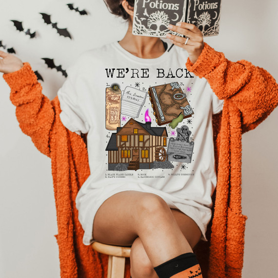 We're Back Sandersons Screen Print Heat Transfer, Halloween-themed T-shirt with haunted house, book, tombstone, and potion designs.