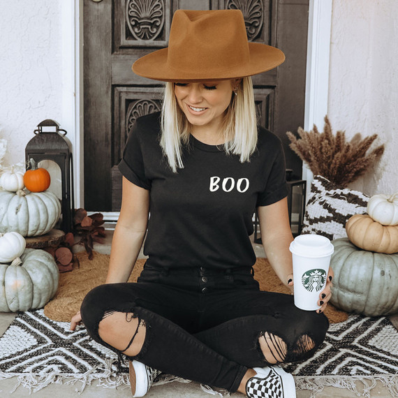 Boo POCKET Screen Print Heat Transfer, woman in black t-shirt with 'BOO' text, sitting on fall-themed pumpkins and decorations.