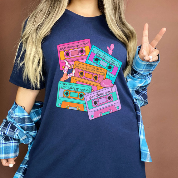 90s Cassette Tapes Screen Print Heat Transfer, colorful cassette tapes with song titles and designs on a navy t-shirt