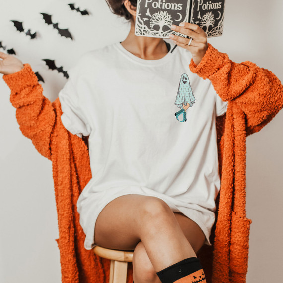 Pocket Ghost Screen Print Heat Transfer, Halloween-themed ghost graphic on white T-shirt with orange fuzzy jacket and Halloween-themed socks.