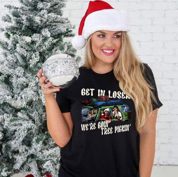 We're Goin' Tree Pickin' Screen Print Heat Transfer, a woman wearing a Christmas Santa hat holding a Christmas ornament with a festive background.