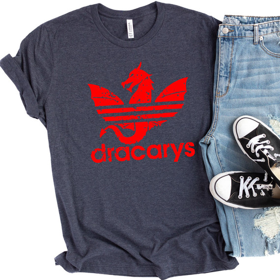 Dracarys GOT Inspired Fan Art DTF Transfer, red dragon silhouette logo on a navy blue T-shirt, with denim jeans and black sneakers in the background.