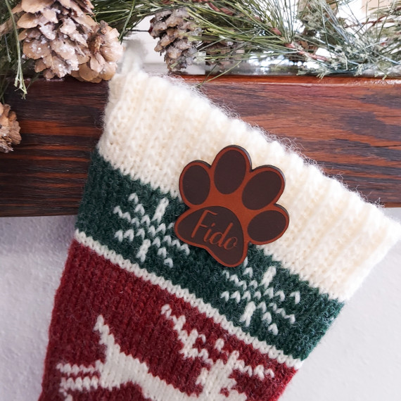 Custom Brown Paw Print Pet Patch, Christmas Stocking with a brown paw print patch and the text 'Fido' on it, on a festive holiday decoration