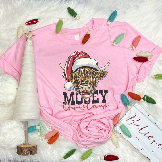 Mooey Christmas DTF Heat Transfer, pink T-shirt with a festive graphic of a Highland cow wearing a Santa hat.