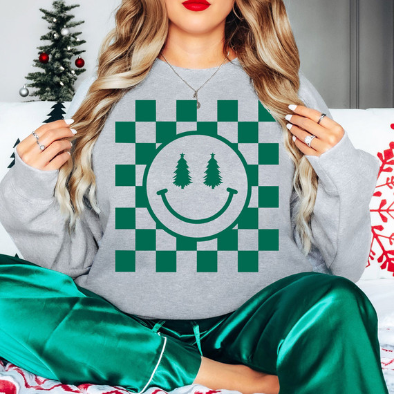 Checkered Christmas Tree Happy Face DTF Heat Transfer, a festive holiday-themed design featuring a smiley face with Christmas trees as eyes and a checkered background, designed for heat transfer on garments.