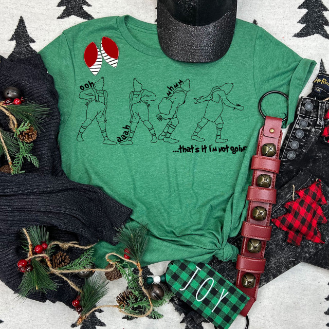 That's It I'm Not Going BLACK DTF Heat Transfer, a green t-shirt with a humorous Christmas design of four dancing figures and text, surrounded by holiday decorations.