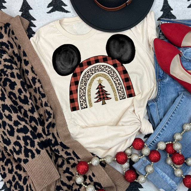Mouse Ears Christmas Rainbow DTF Heat Transfer, festive Christmas-themed rainbow with mouse ears design on a t-shirt surrounded by holiday accessories.