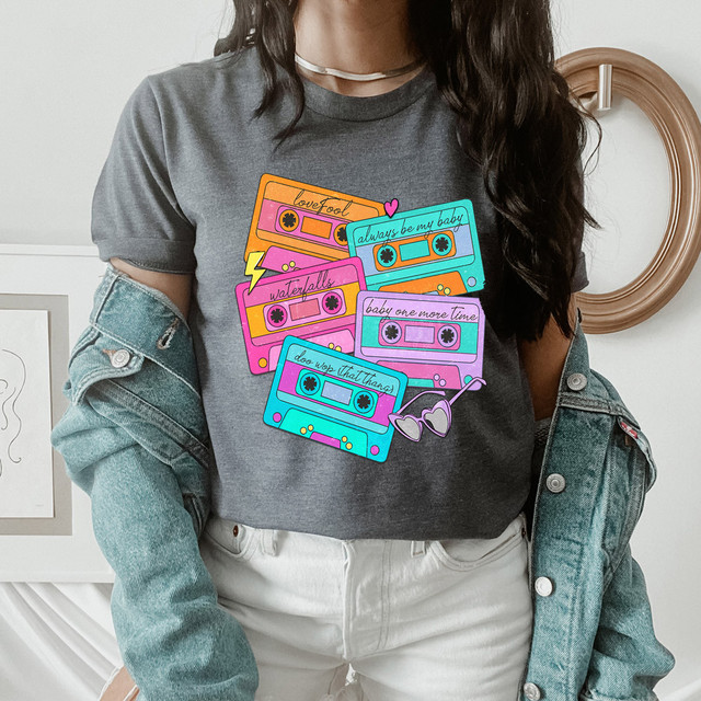 90s Pop R&B Cassette Tapes DTF Heat Transfer, colorful illustrated cassette tapes with retro designs and text, worn by a person wearing a gray t-shirt and a denim jacket.