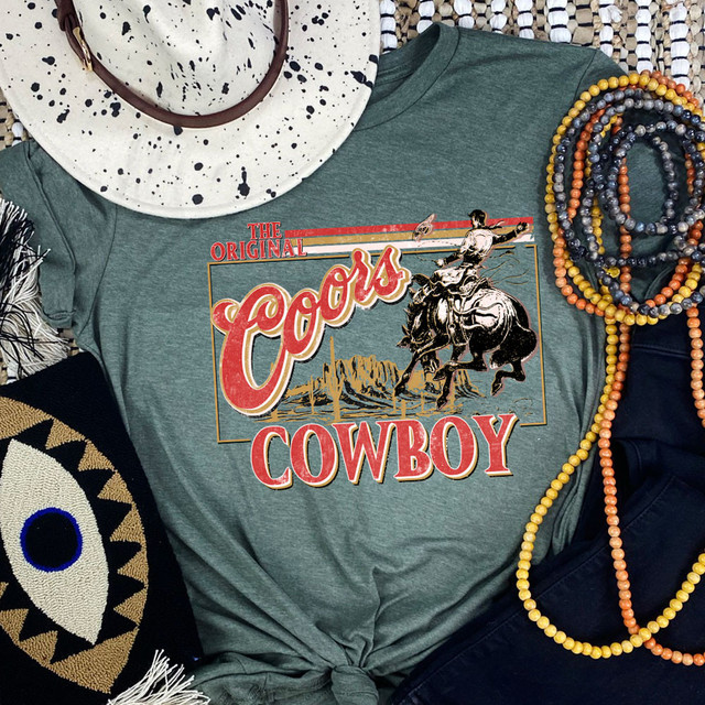 The Original Cowboy DTF Heat Transfer, graphic t-shirt with cowboy riding a bucking horse design.