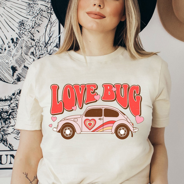 Love Bug Screen Print Heat Transfer on T-shirt, cute car with hearts and the text 'Love Bug' in bold colorful letters.