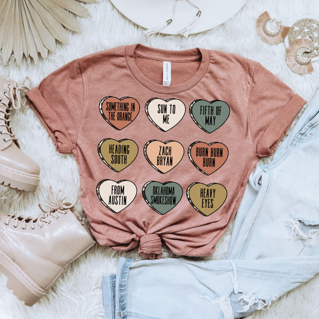 Zack Hearts DTF Heat Transfer, colorful heart-shaped design with various text phrases on a pink T-shirt.