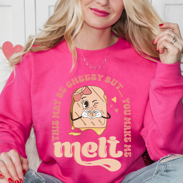 This May Be Cheesy DTF Heat Transfer, a pink sweatshirt with a cute melting bread cartoon character and the phrase 'You're Cheesy But... You Make Me Melt' in playful font.