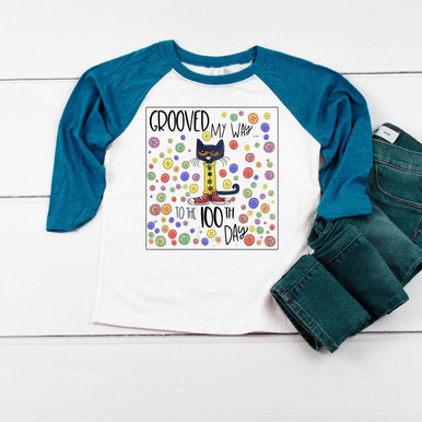 Pete Grooving Into 100 Days DTF Heat Transfer, colorful cartoon design of a grooving black cat on a white and blue raglan shirt with multicolored circles.