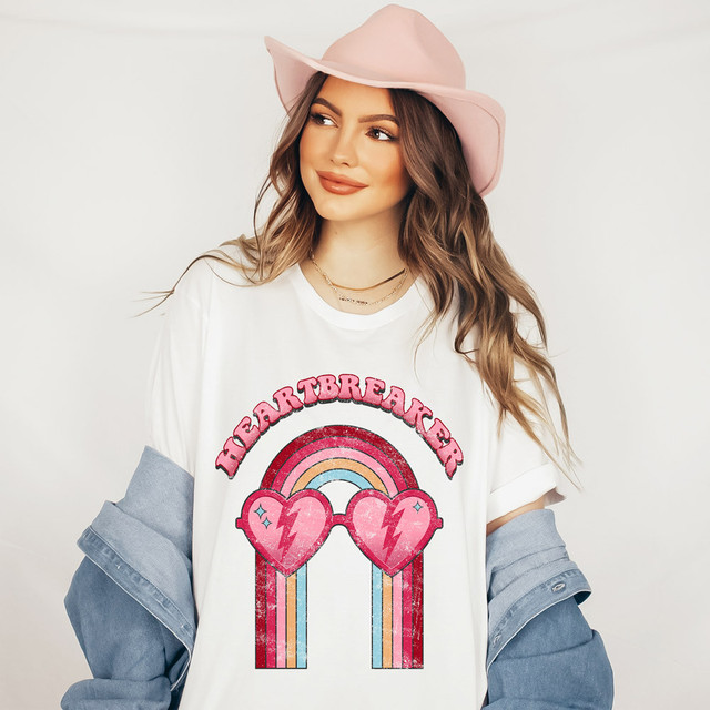 Heartbreaker DTF Heat Transfer, a woman wearing a white t-shirt with colorful rainbow and heart-shaped sunglasses design