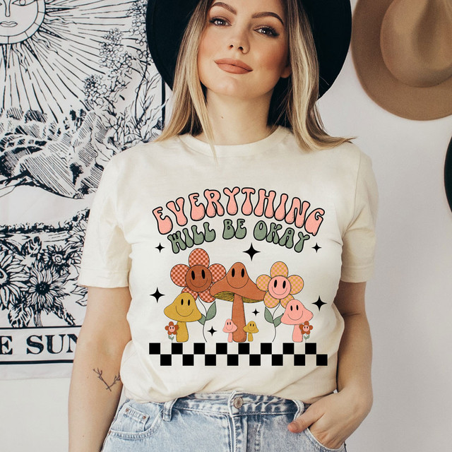 Everything Will Be Okay DTF Heat Transfer, colorful mushroom and flower design with the text 'Everything Will Be Okay' on a woman's T-shirt.