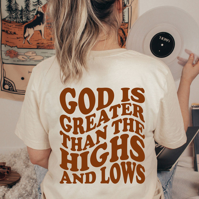 God Is Greater Than The Highs And Lows DTF Heat Transfer, T-shirt with inspirational religious message printed on the back.