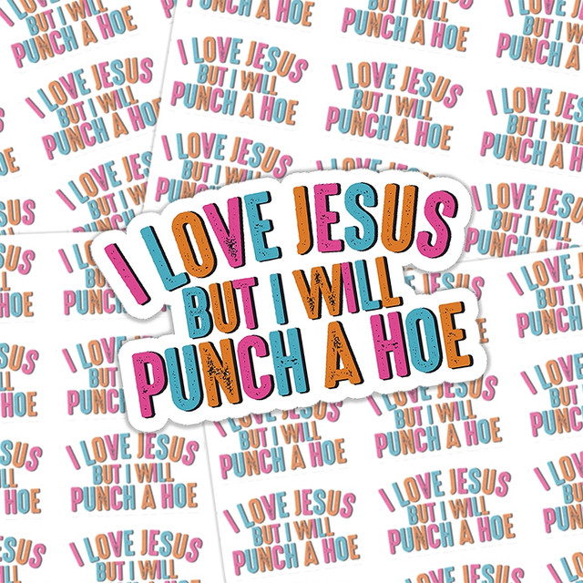 Product I Love Jesus But I Will Punch A Hoe Sticker Sheet, colorful sticker with bold text 'I Love Jesus But I Will Punch A Hoe' in vibrant pink, orange, blue, and black colors.