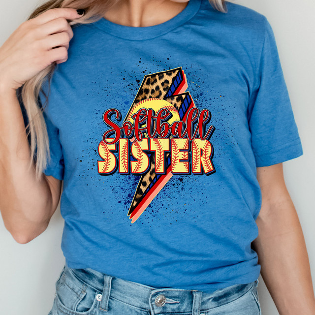 Softball Sister Lightning Bolt DTF Heat Transfer, colorful printed design featuring a lightning bolt with animal print pattern and vibrant text on a blue t-shirt.