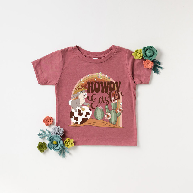 Howdy Easter DTF Heat Transfer, pink children's T-shirt with Easter-themed graphic design featuring a bunny, cacti, and colorful flowers.