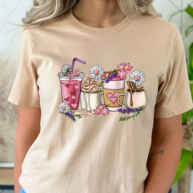 Mama Lattes DTF Heat Transfer, colorful coffee-themed illustration on a beige t-shirt showing various coffee drinks with flowers and decorative elements.