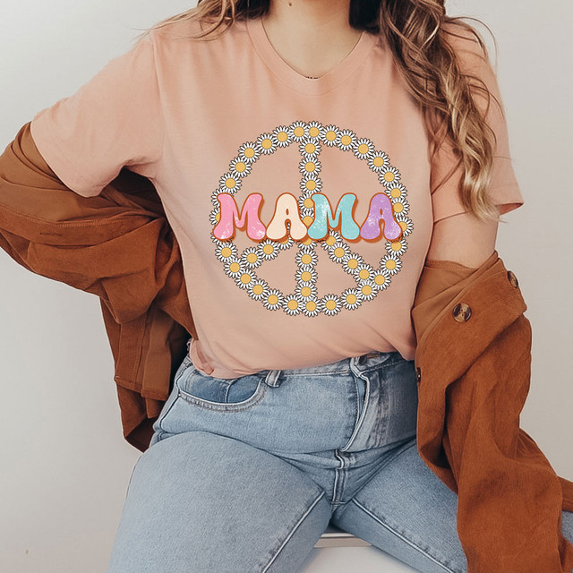 Mama Peace Retro DTF Heat Transfer, colorful peace sign with daisy flowers and the word 'Mama' in pastel colors on a woman's t-shirt.