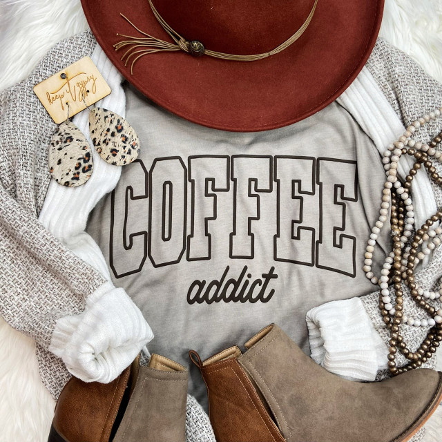 Coffee Addict PUFF Screen Print Heat Transfer, close-up of a stylish outfit with a 'Coffee addict' graphic t-shirt, accessories, jewelry, and boots.