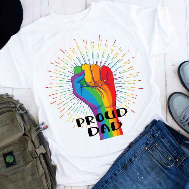 Pride Fist Proud Dad Rainbow Burst Sublimation Transfer, a colorful rainbow-colored fist graphic on a white T-shirt.