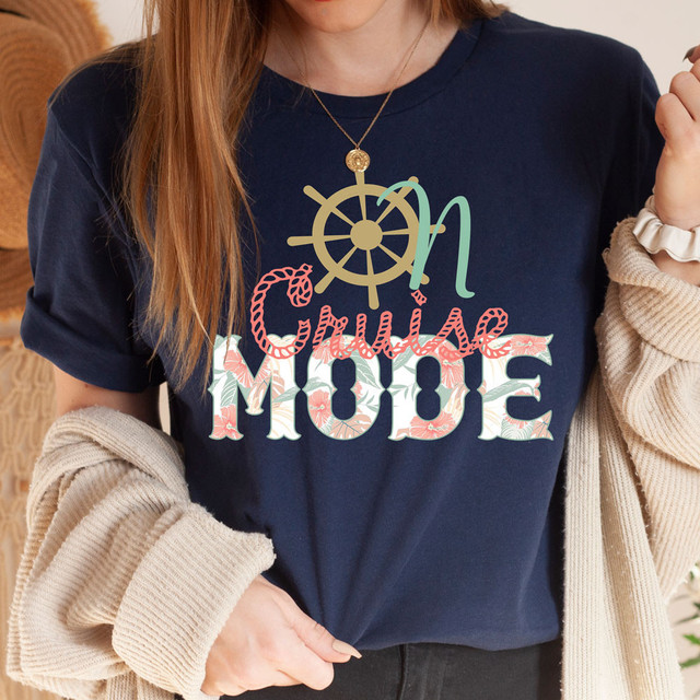 On Cruise Mode DTF Heat Transfer, colorful and festive holiday-themed design on a navy blue T-shirt.
