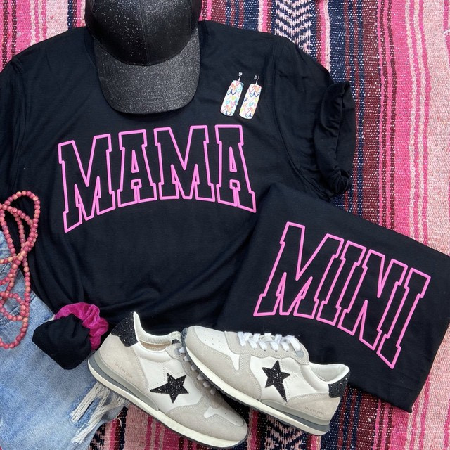 Mini PUFF YOUTH Screen Print Heat Transfer, black t-shirt with 'MAMA' and 'MINI' designs in pink outline, alongside accessories including white sneakers with black star accents, a black cap, earrings, a pink beaded bracelet, and a pink and black woven textile background.