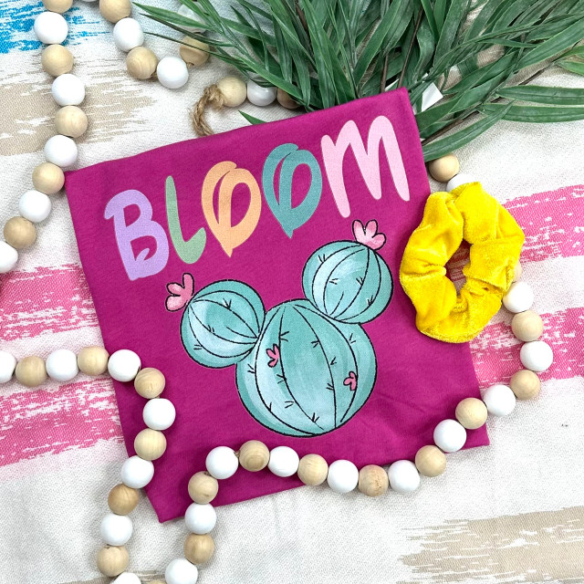 Bloom Cactus Mouse Ears Screen Print Heat Transfer, colorful cactus design on pink fabric with the word 'BLOOM' in pastel colors.